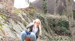 Young girl with long blonde hair Katy Sky pulls down her jeans to pee outside
