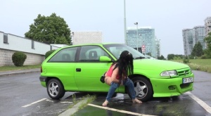 Dark haired girl Miriam squats for an urgent piss behind a parked car