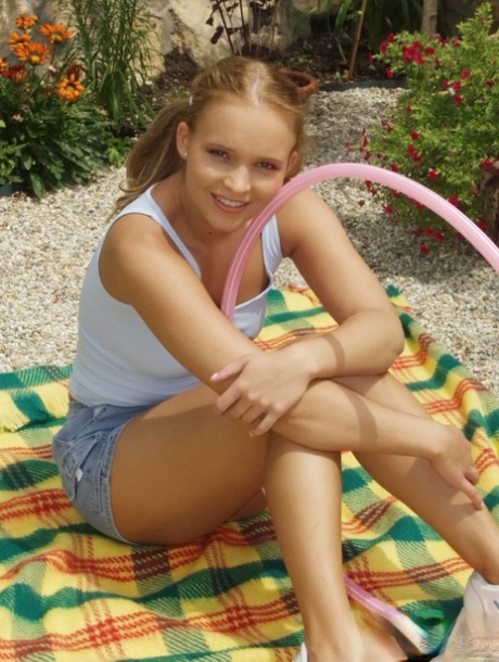 Blonde amateur puts down her hula-hoop and flashes her small tits