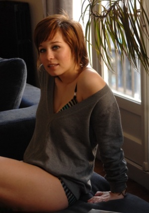 Cute redhead Sofia sheds sweater to pose seductively in sexy underwear