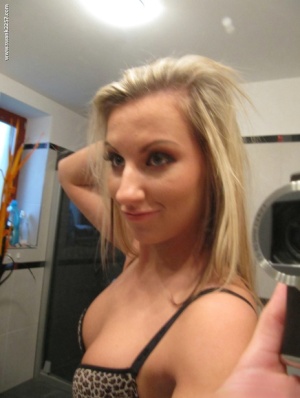Blonde amateur gets totally naked while taking self shots in a bathroom mirror