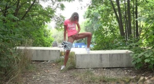 Hot blonde takes off her shorts to pee