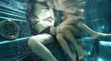 Old and young lesbians kiss in a hot tub after a sauna session