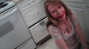 Topless lady Natalia pees her pants while sporting a ball gag