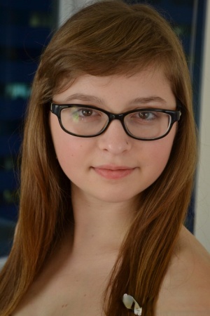 Nerdy teen Lilah Demaray fingers her horny pussy wearing glasses only
