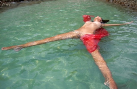 Teen model Nov Lera gets totally naked in pristine ocean water off the coast