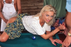Blue-eyed blonde Monika Bella fucks two guys on top of a pool table