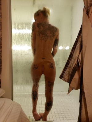 Tattooed girl with fake tits has sex in a bathroom with a tattooed man