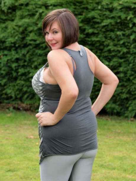 Amateur plumper Roxy uncovers her huge tits before touching her twat in a yard