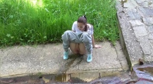 Short taken girl Antonia Sainz squats for a piss on a sidewalk