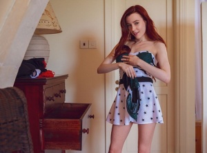 Stunning Red haired Sherice lifts the hem of her polka dot mini dress and