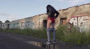 Petite brunette Natasha squats for a piss in a puddle on a gravel road