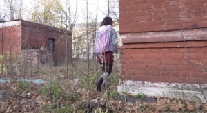 White girl Rita bares her bum while taking a piss by an abandoned building