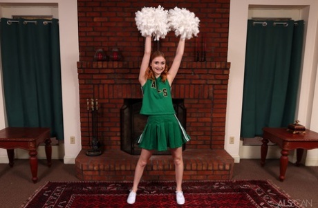 Young redheaded cheerleader Scarlet Skies gets naked for Kegel exercises