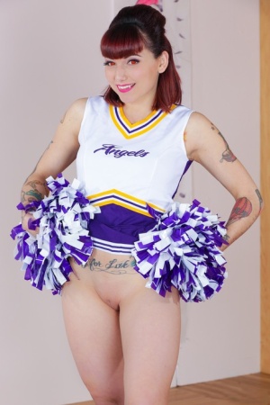 Tattooed cheerleader Veronica Layke offers up naked pussy on her knees