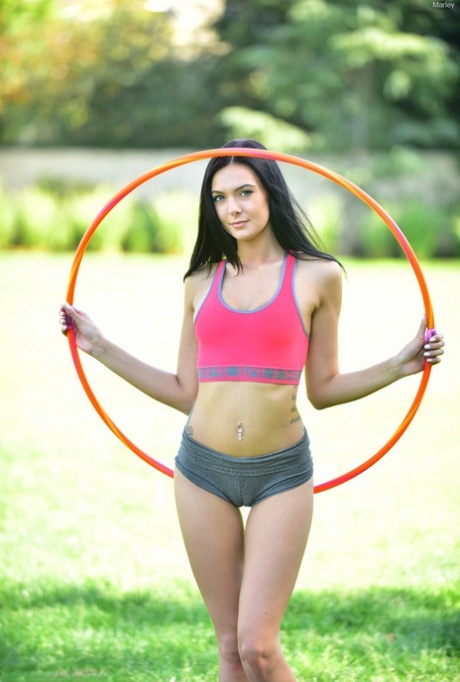 Sporty skinny girl playing bare ass at park  toying with baseball bat