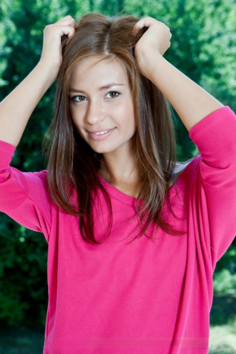 Leggy teen Irina J works free of a pink dress to pose nude on a balcony 19690241