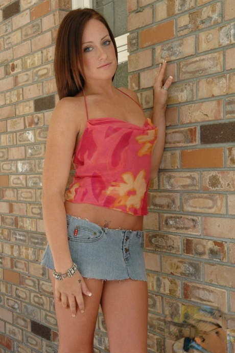 Redhead amateur Kylie places hands over her naked tits against a brick wall 41830255
