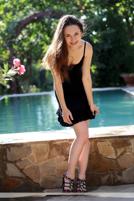 Nice girl Valyn removes a little black dress to get naked near a swimming pool 97894589