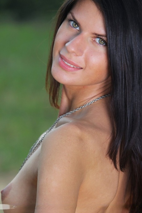 Pretty brunette Katrina gets completely naked on a dirt path in a field 87727263
