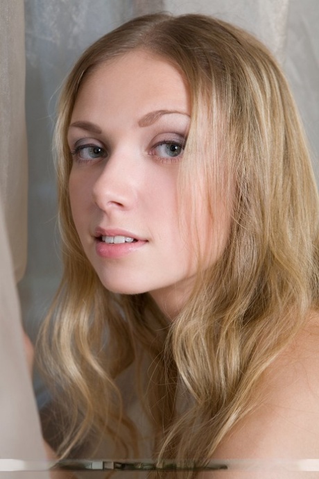 Long haired teen Augusta models butt naked in a confident fashion