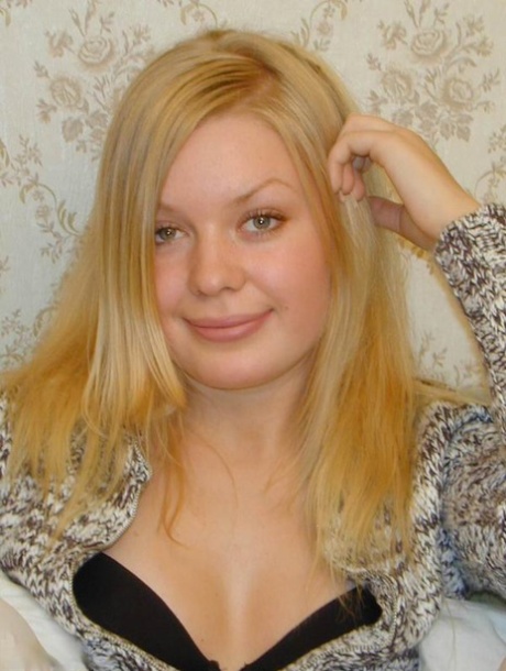 Young blonde Annya slides her black panties aside to expose her pussy