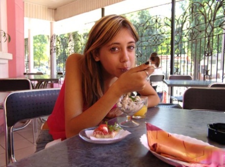Nice teen flashes her upskirt underwear while having a bite to eat 15991409
