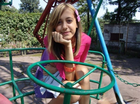Young looking girl exposes her thighs during upskirt action at a playground 22309522