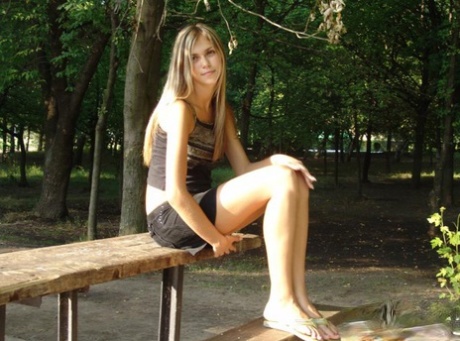 Young blonde exposes her tits and pussy well in a public park 37167997