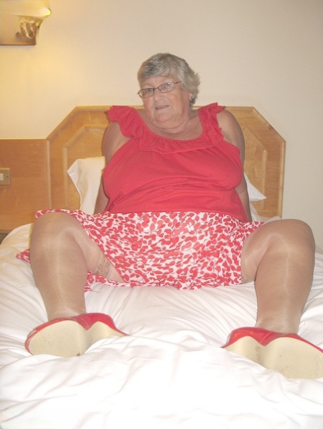 Fat British lady Grandma Libby toys her pussy on a bed in nylons and garters 98708834
