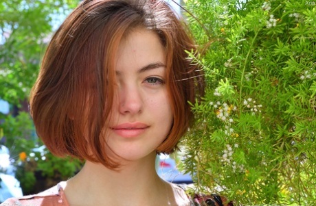 Pretty natural redhead Aria-II undressing outdoors to flaunt her nice big tits 24995373