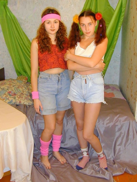 Young looking lesbians use sex toys while having sex on their bed 78819831