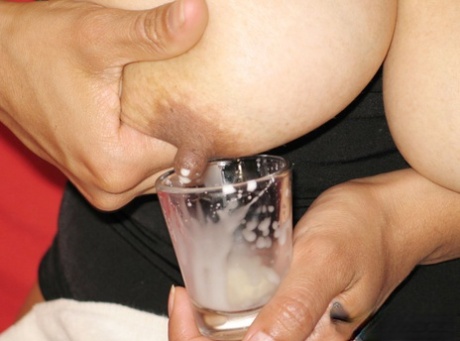 Latina chick fills a shot glass with breast milk before drinking it 44916405