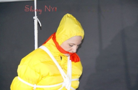 White girl sports a gag while restrained with rope in yellow rainwear 90058324