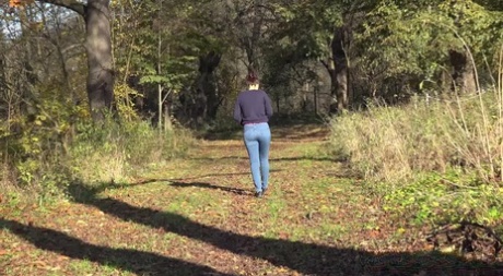 Caucasian girl Antonia Sainz pulls down her blue jeans for a piss in nature 88731938