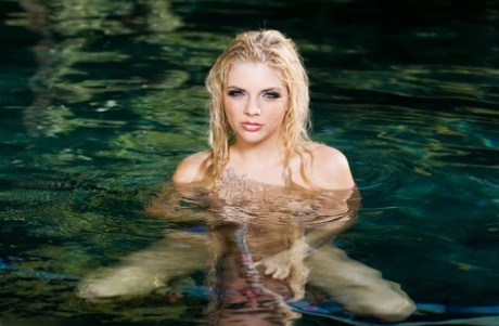 Beautiful blonde Jana Jordan models totally naked in a swimming pool 58822787