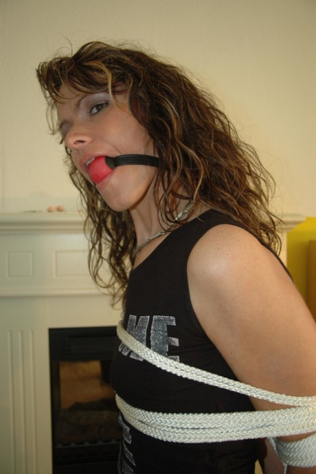 Caucasian female has her arms tied behind her back while ball gagged 42382853