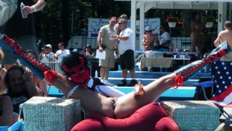 Men and women take in an outdoor strip show at a clothing optional club 33166049