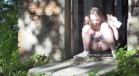 Caucasian girl Vika takes a pee in the doorway of an abandoned building 93277834