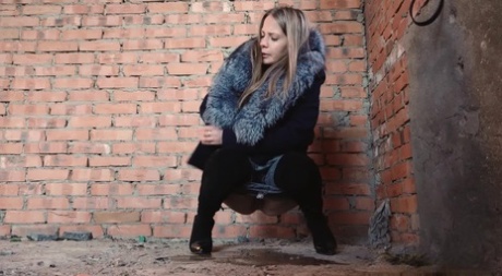 Distressed girl squats for an outdoor piss while wearing a heavy winter coat 17713052