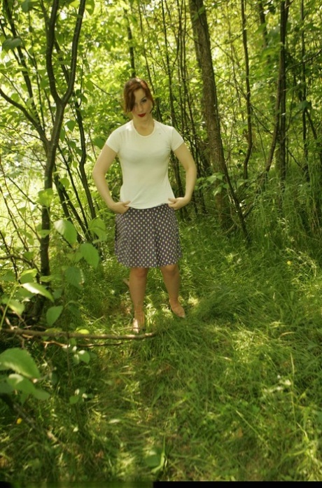 Redhead amateur pulls down satin panties in the woods before dressing 57534445