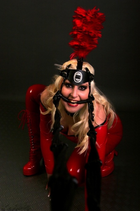 Blonde female models a red latex ponygirl outfit during a non-nude session 70413326