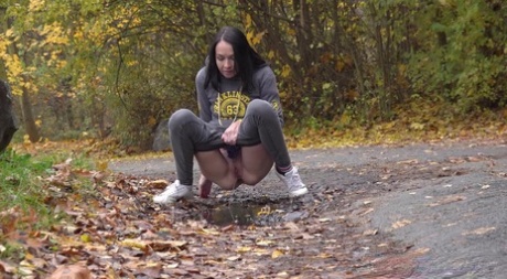 Dark-haired girl Mistica takes a pee on a path while walking in a wooded area 72810666
