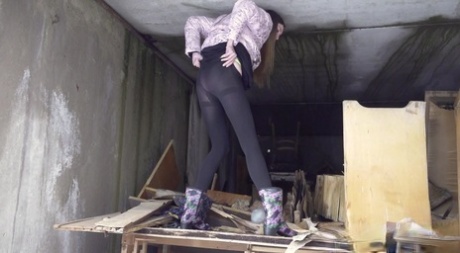 Distressed girl takes a piss on a table in an abandoned building 73454720