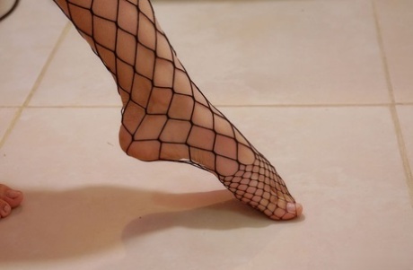 Alluring teen Briana dons a mask before toying her pussy in fishnet pantyhose 82032674