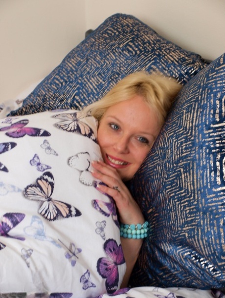 Sleeping blonde Sindy Bust wakes up and proceeds to get totally naked 49510744