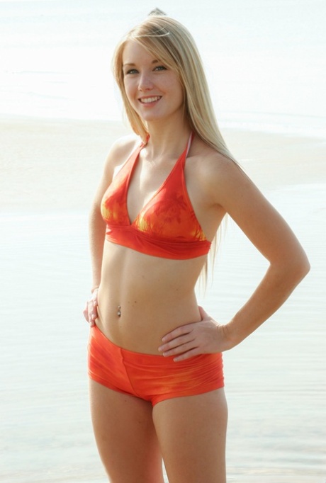 Beautiful blonde Jewel removes swimwear to go totally nude in shallow water 80476723