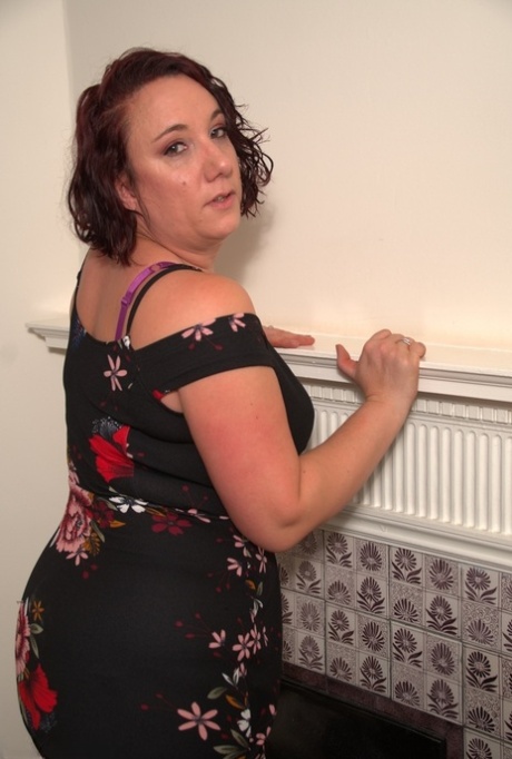 Mature lady discards her dress to model in her underthings and nylons 70567820