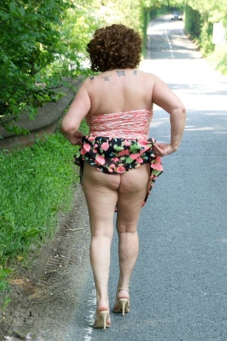 Mature lady gets her natural tits out while stepping into shallow water 39470657