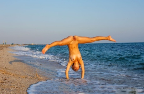 Naked teen Tienette O displays her flexibility during a trip to the beach 31963934